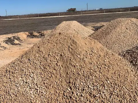 Stockpiles of base material delivered to a job site