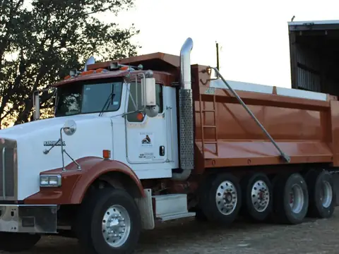Barcenas Transportation dump truck with an orange bed